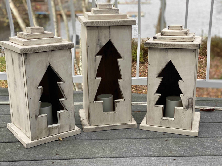 Handcrafted natural wooden lanterns with tree cut-out design, available in various sizes and perfect for indoor or outdoor use.