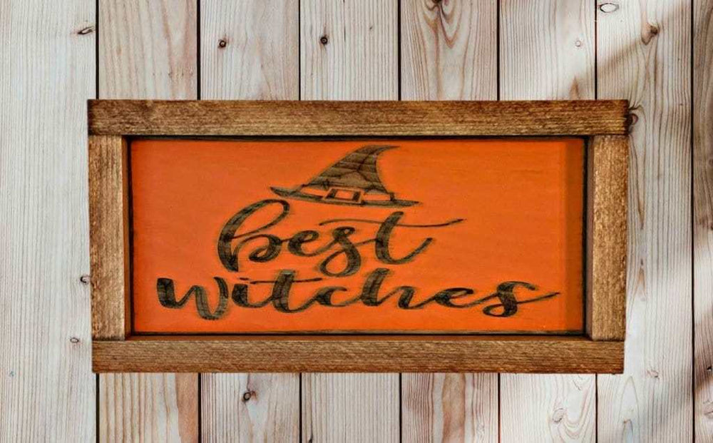 Halloween sign with "Best Witches" text and witch hat, laser-engraved on orange pine wood, rustic frame.