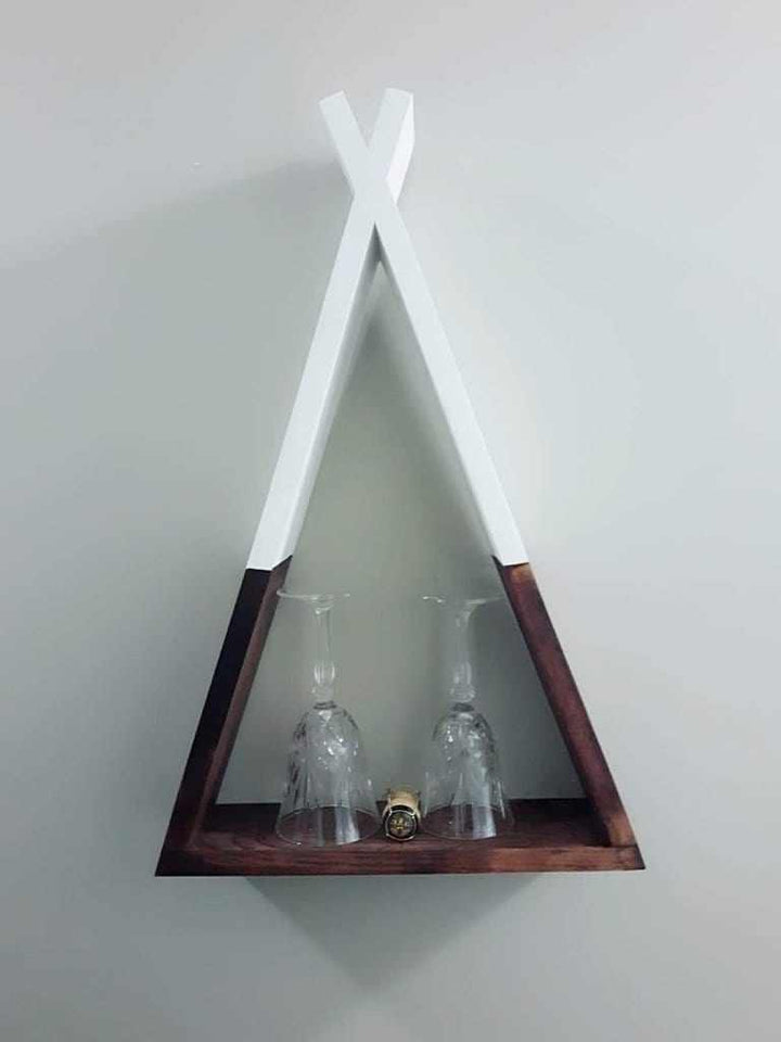 Handcrafted wooden teepee shelf displaying glasses, unique home decor.
