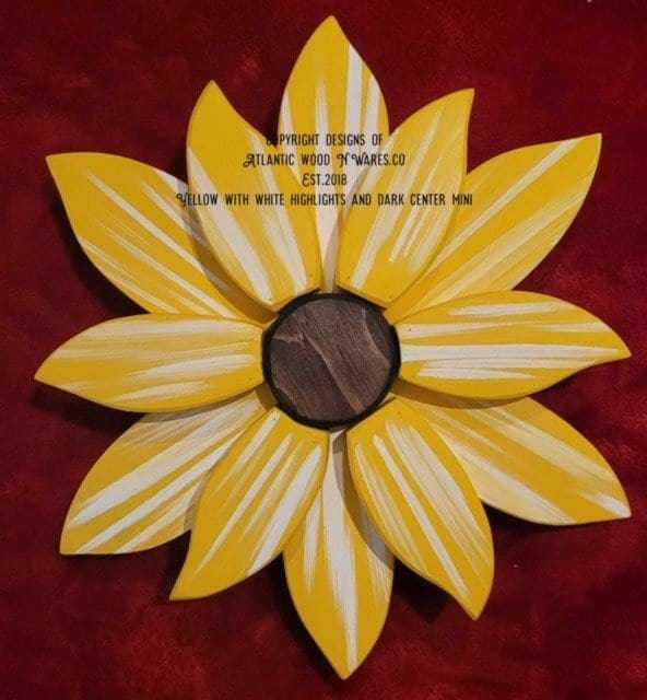 Yellow wooden flower art piece with white highlights and dark center, handcrafted for home decor.