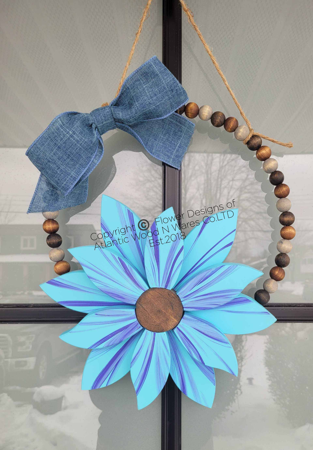 Boho style wooden bead wreath with painted wood flower and hand-stained beads.