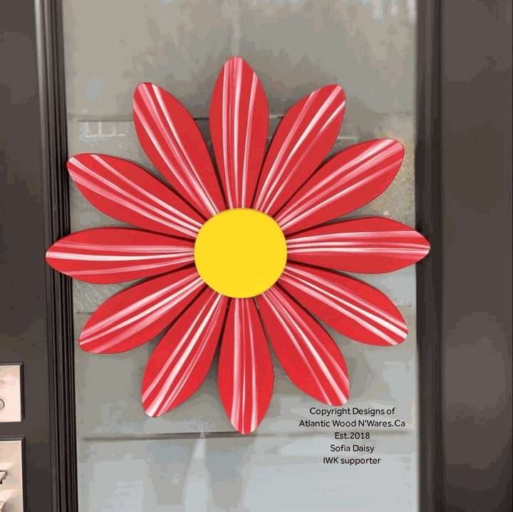 Handmade wooden flower art Sofia Daisy with red petals and yellow center, symbolizing hope and support for heart transplant children.