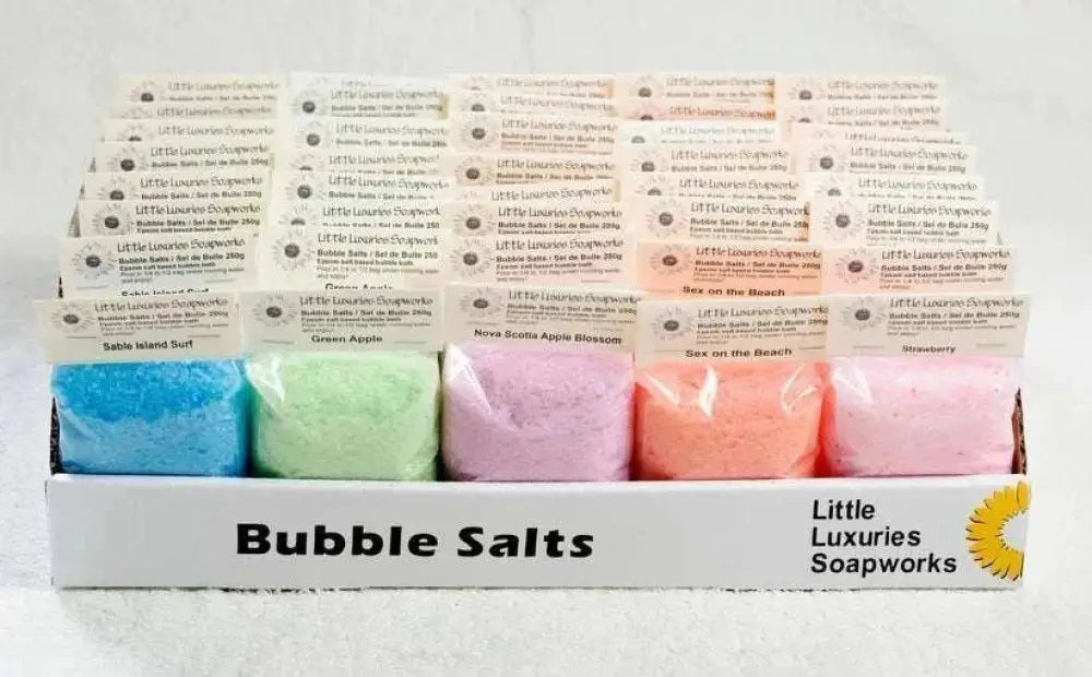 Assorted colorful bubble bath salts in resealable pouches by Little Luxuries Soapworks for relaxing and hydrating skin.