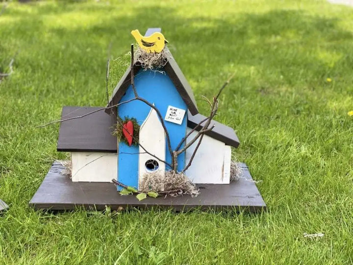 Handcrafted triple birdhouse with colorful design featuring personalized sayings, perfect for garden decoration.