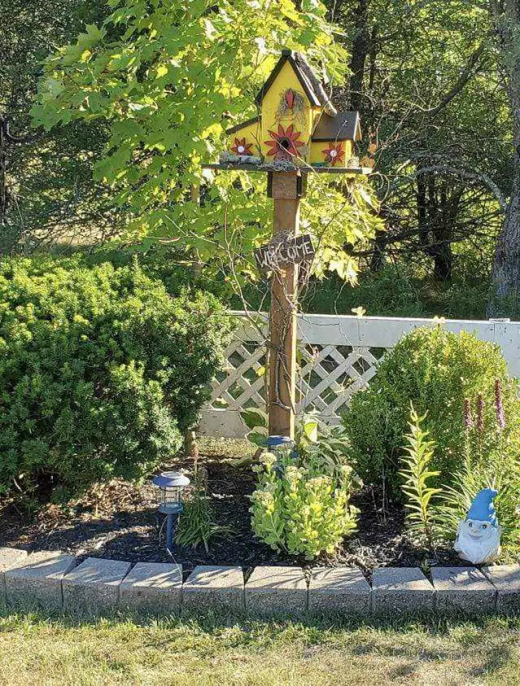 Triple birdhouse in garden, yellow design, sturdy pine wood, decorative and functional bird lover gift.