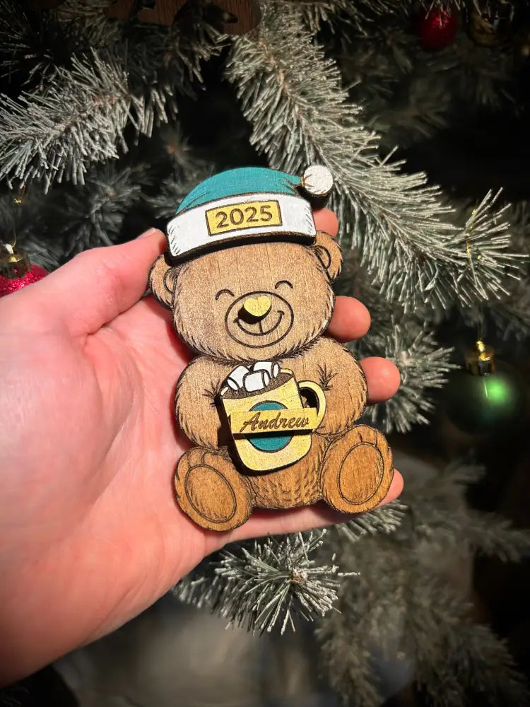 Custom wooden bear ornament with teal and white 2025 Santa hat holding Andrew mug