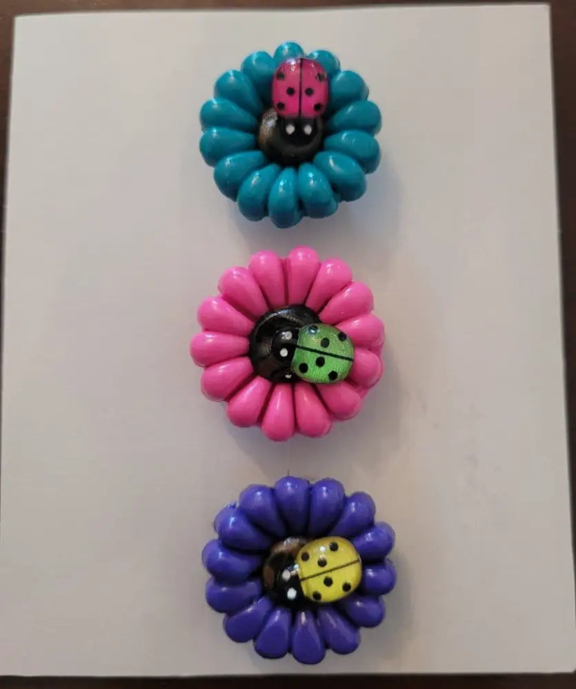 Daisy and Ladybug & Bees Polymer Clay Fridge Magnet Set in blue, pink, and purple designs.