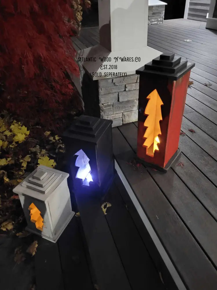 Handcrafted wooden lanterns with intricate designs in various sizes, illuminating a cozy outdoor space.