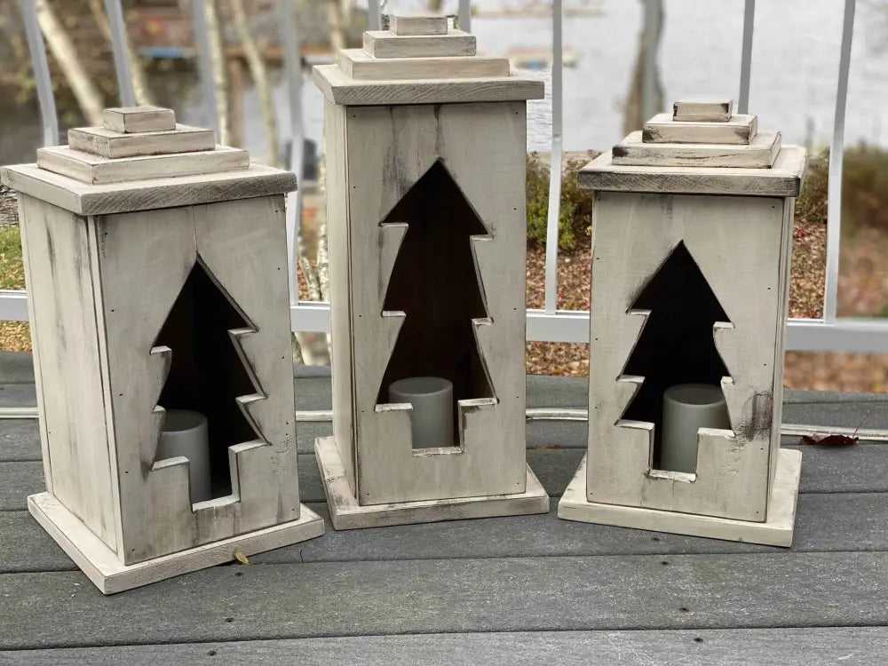 Handcrafted natural wooden lanterns with tree cut-out design, available in various sizes and perfect for indoor or outdoor use.