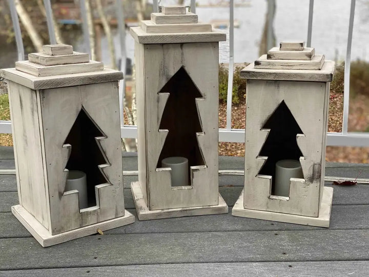 Handcrafted natural wooden lanterns with tree cut-out design, available in various sizes and perfect for indoor or outdoor use.