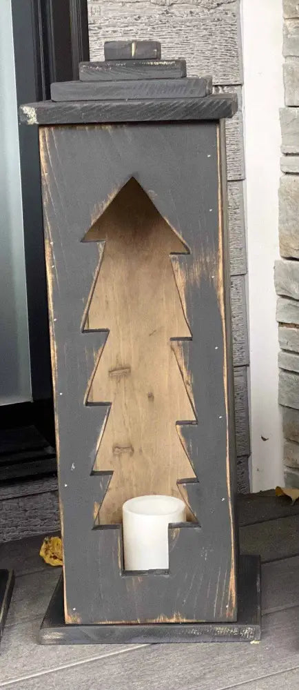 Handcrafted wooden lantern with intricate designs emitting warm light.