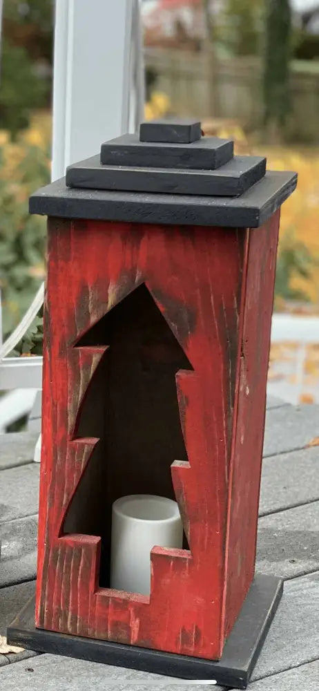 Handcrafted wooden lantern with intricate cutout design, ideal for cozy decor.