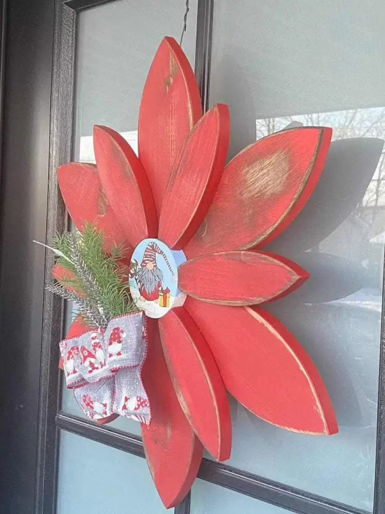 Hand-painted Christmas flower gnome décor with red antique petals and festive bow for outdoor display.