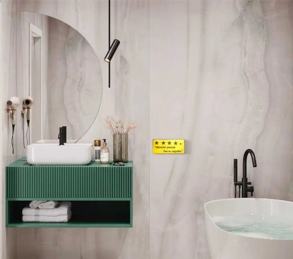 Rustic bathroom decor with "Would Poop Here Again" sign, adding humor and style.