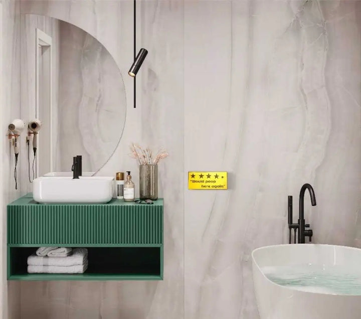 Rustic bathroom decor with "Would Poop Here Again" sign, adding humor and style.