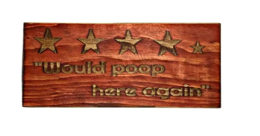 Rustic "Would Poop Here Again" bathroom sign with stars engraved on wood.