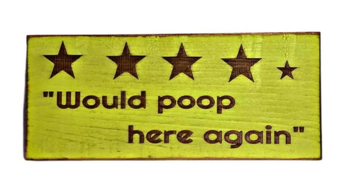 Rustic bathroom sign with "Would Poop Here Again" slogan and four and a half stars.