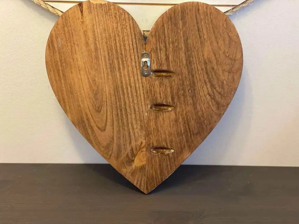 Handcrafted wooden hearts wall art decor with natural finish and wall hanger attachment.