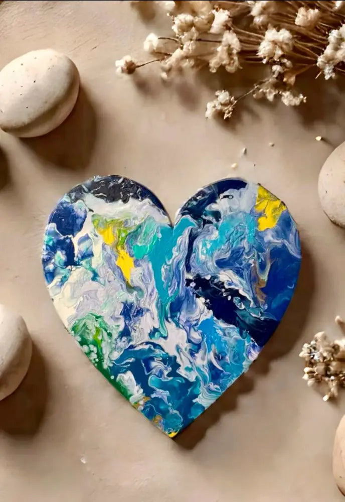 Handcrafted artisan wooden heart wall art with abstract blue, green, and yellow acrylic paint design on pine wood