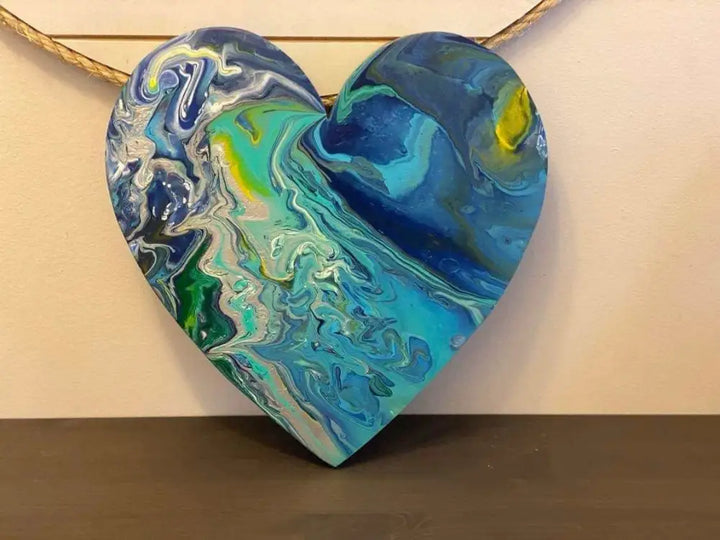 Handcrafted artisan wooden hearts wall art decor with blue and green acrylic paint design.