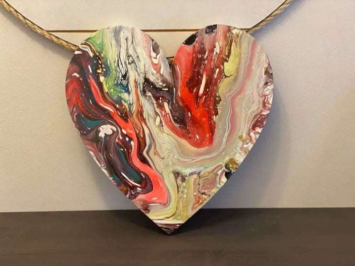 Handcrafted artisan wooden hearts wall art decor with vibrant acrylic paint design.