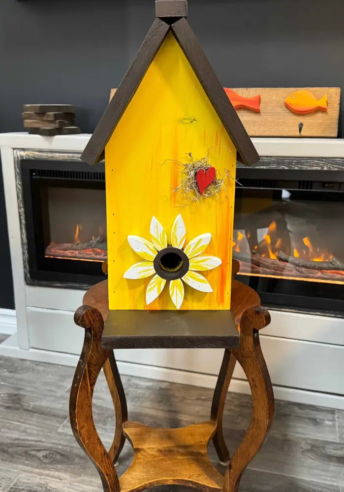 Handcrafted Canadian pine birdhouse with sunflower design and rustic charm for outdoor garden decor