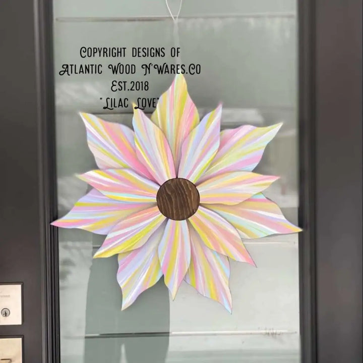 Handcrafted Love Flower door decoration in pastel colors with a wooden center, suitable for all seasons.