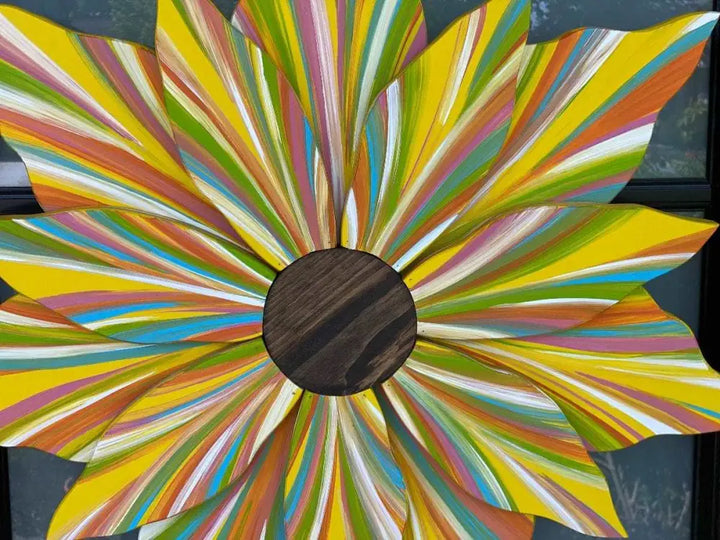 Handcrafted flower door decoration with colorful petals and a wooden center.