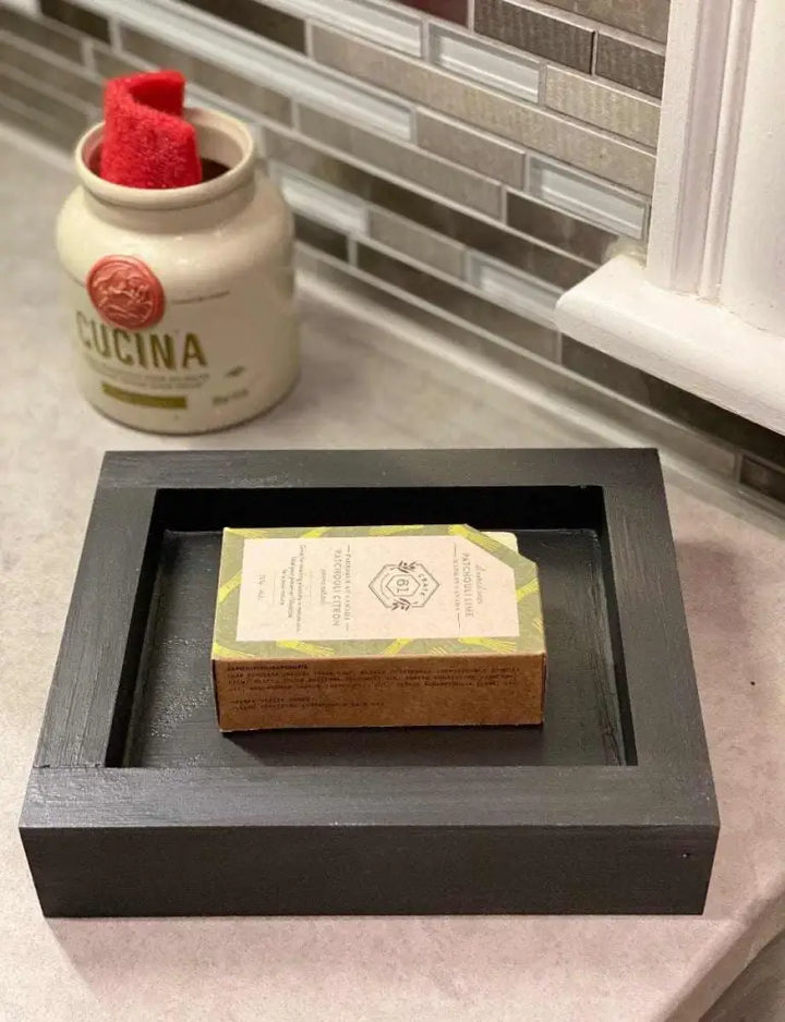 Handcrafted pine soap dish in modern kitchen setting.