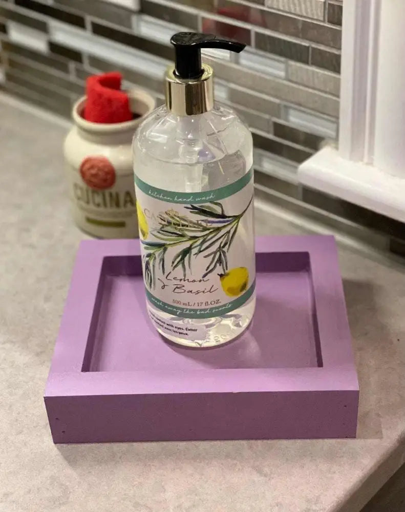 Handcrafted purple pine soap dish with hand soap bottle on a kitchen counter.