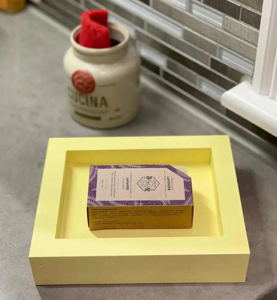 Handcrafted yellow pine soap dish with a bar of soap in a kitchen setting.