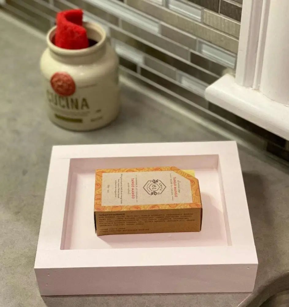 Handcrafted pine soap dish in white, displayed on a kitchen counter.