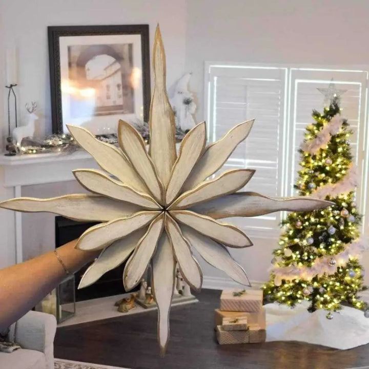 Handcrafted snowflake decoration with pine construction, displayed indoors, capturing Maritime winter beauty.