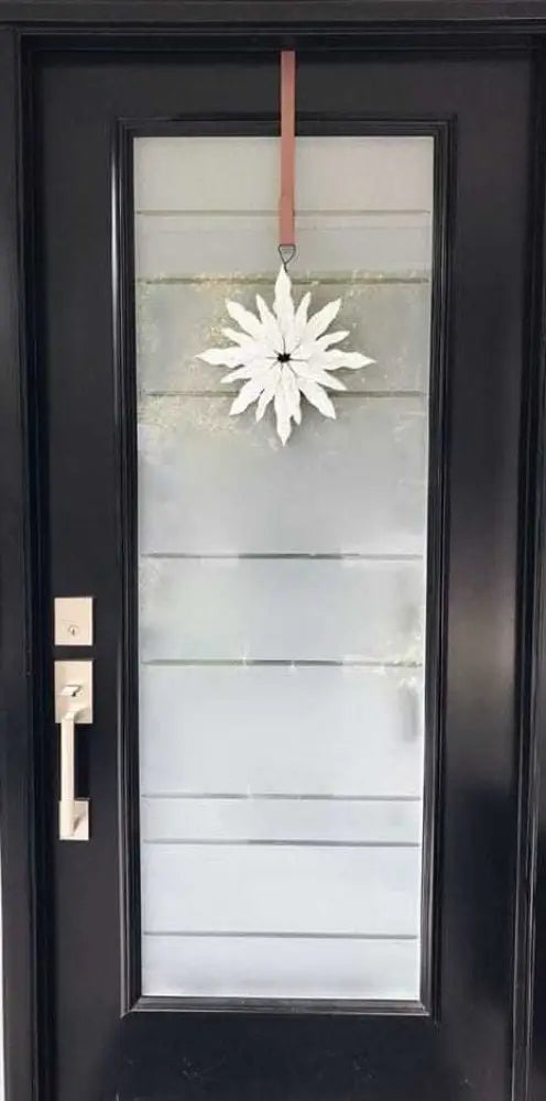 Handcrafted snowflake decoration on front door, reflecting Maritime winter beauty.