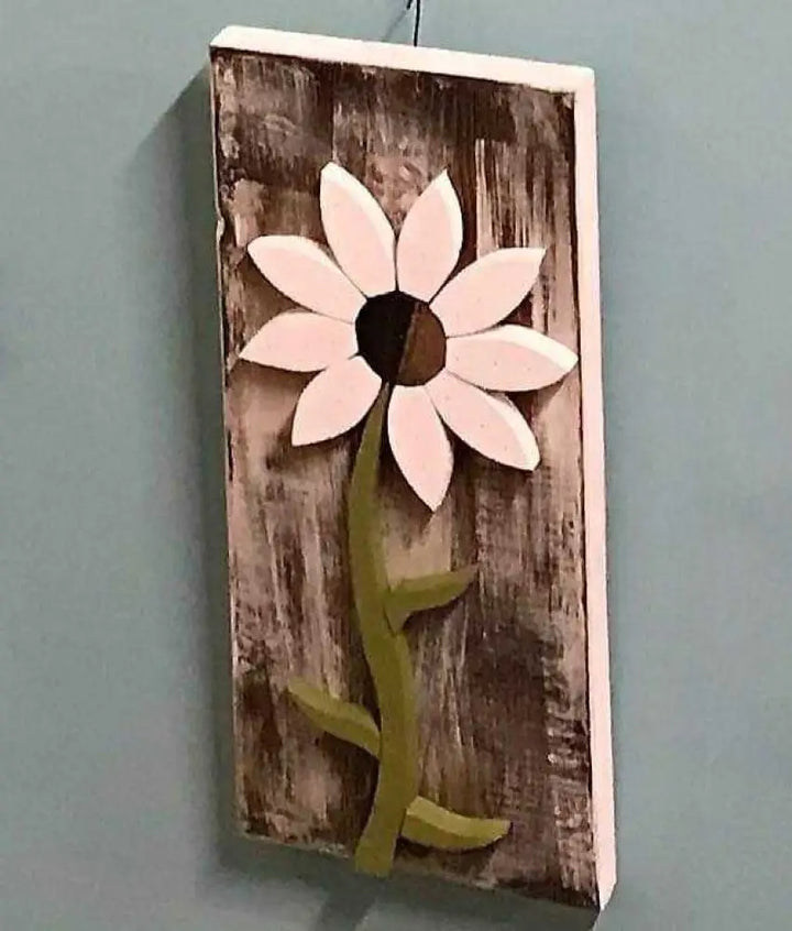 Handcrafted pine wood wall art flower with white petals and green stem on distressed brown background, eco-friendly and customizable decor panel.