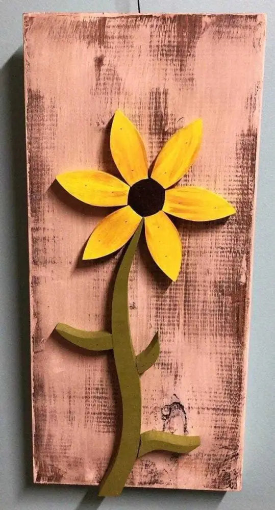 Handcrafted yellow flower wall art on distressed wooden panel with green stem and hook for hanging