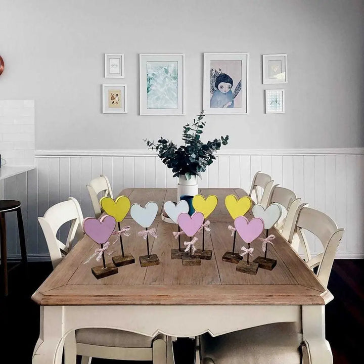 Handcrafted wooden hearts with bows on a table, adding rustic charm to home decor.