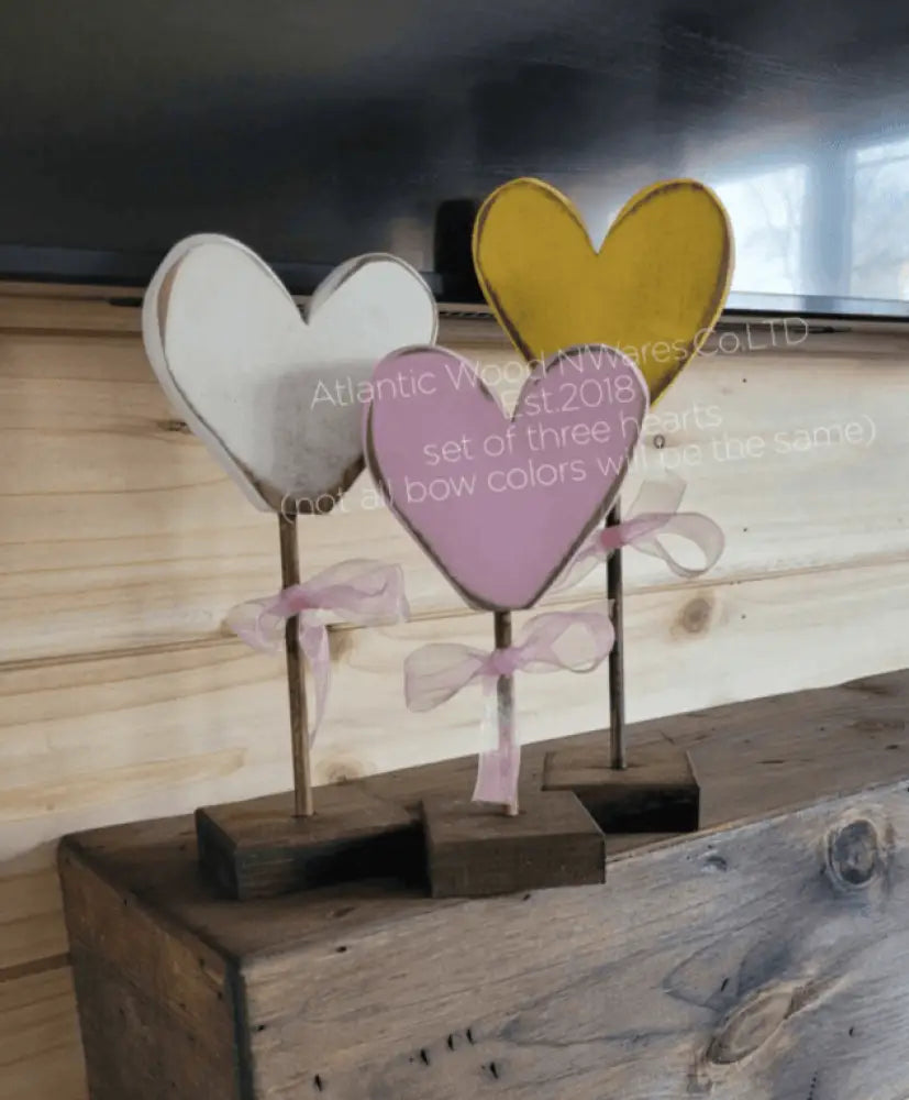 Handcrafted wooden hearts with colorful bows, perfect gift for loved ones.