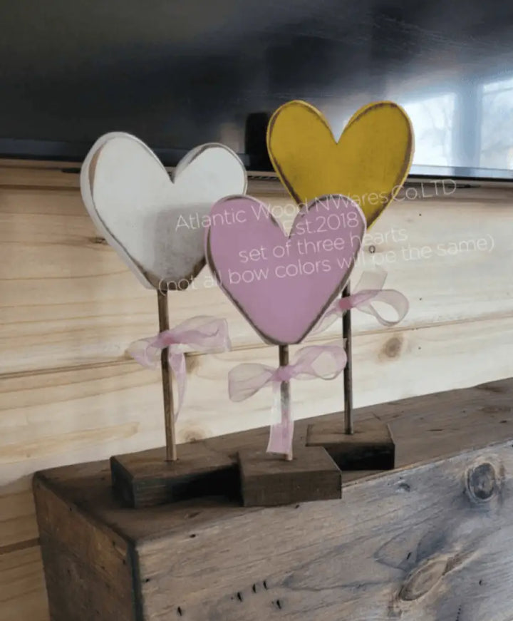 Handcrafted wooden hearts with colorful bows, perfect gift for loved ones.
