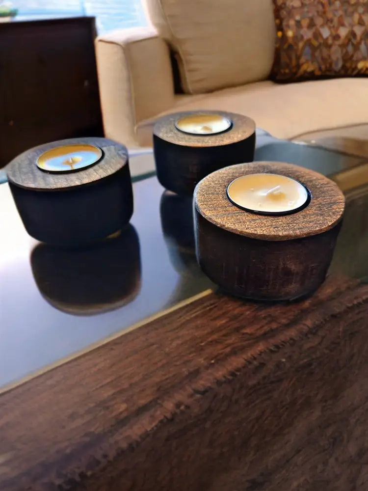 Handcrafted wooden tea light holders on a table, unique home décor item.