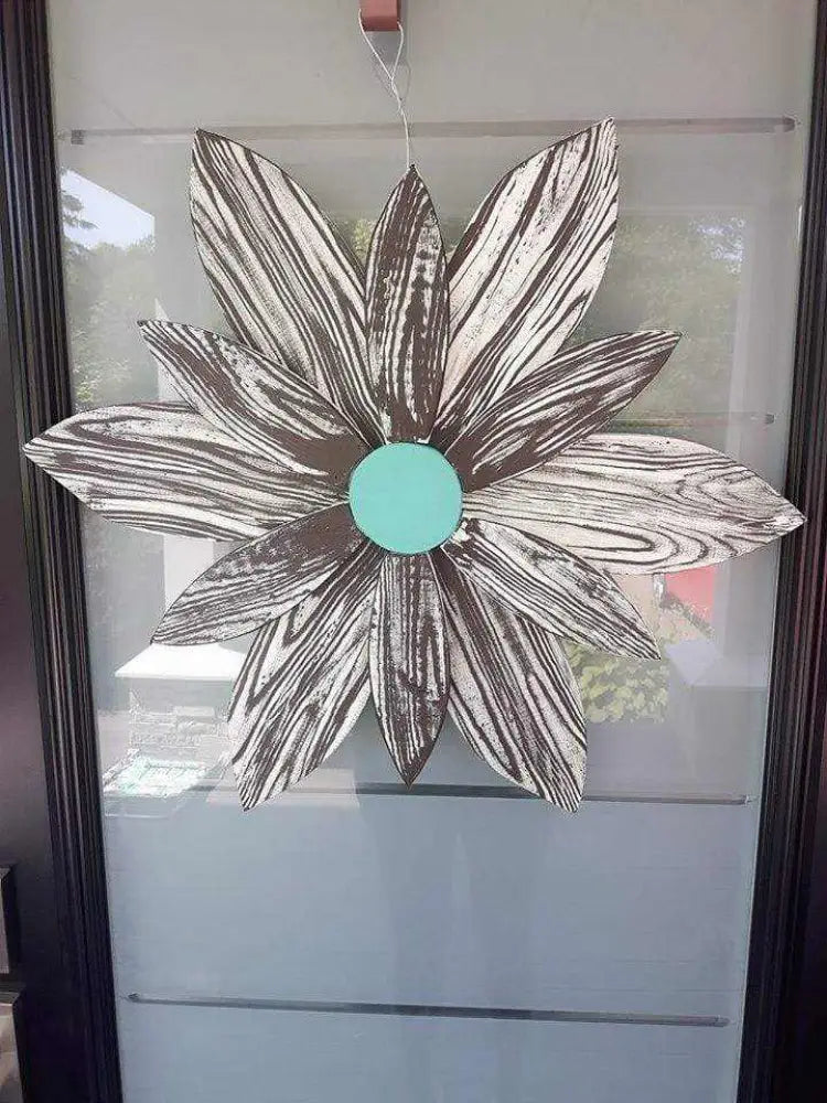 Handcrafted zebra-themed wooden flower decor with chocolate brown and white stripes.