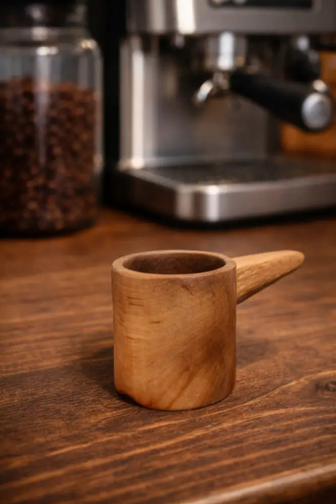 Handmade rustic wooden coffee scoop with smooth finish and small handle
