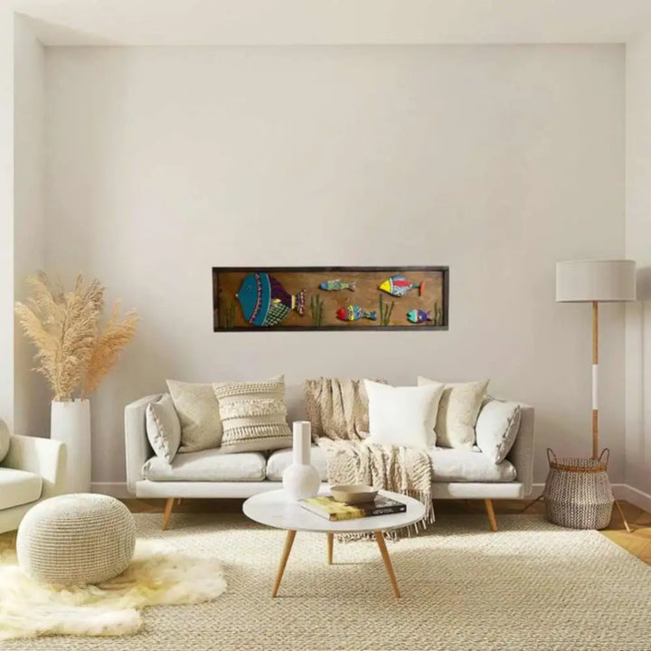 Handmade wooden fish wall art with vibrant hand-painted colors, 37.5 by 10.75 inches, displayed above a modern sofa in a cozy living room.