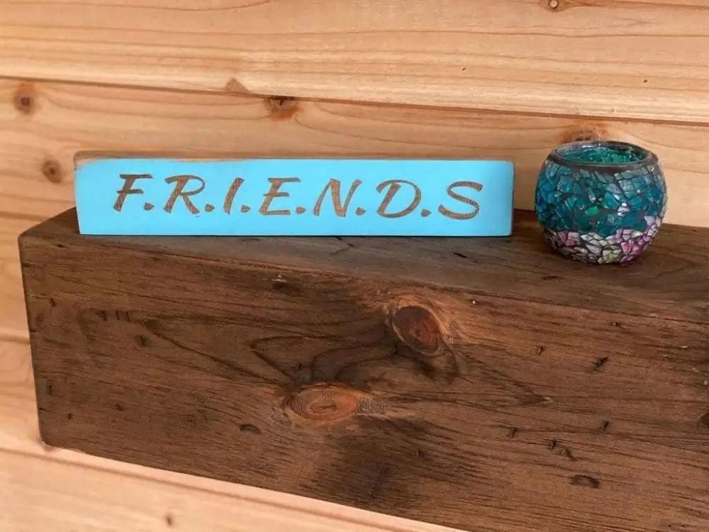 Laser engraved friendship sign on wood, featuring the word "FRIENDS", perfect gift for best friends.
