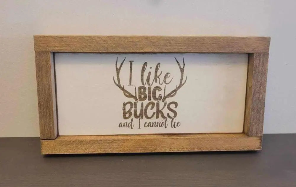 Laser engraved wood sign with antler design and "I like big bucks and I cannot lie" text.