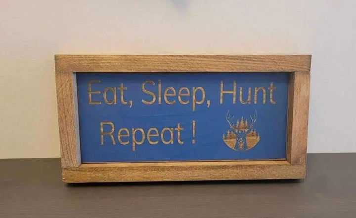 Laser engraved wood sign with "Eat, Sleep, Hunt, Repeat!" design, perfect for outdoor enthusiasts.