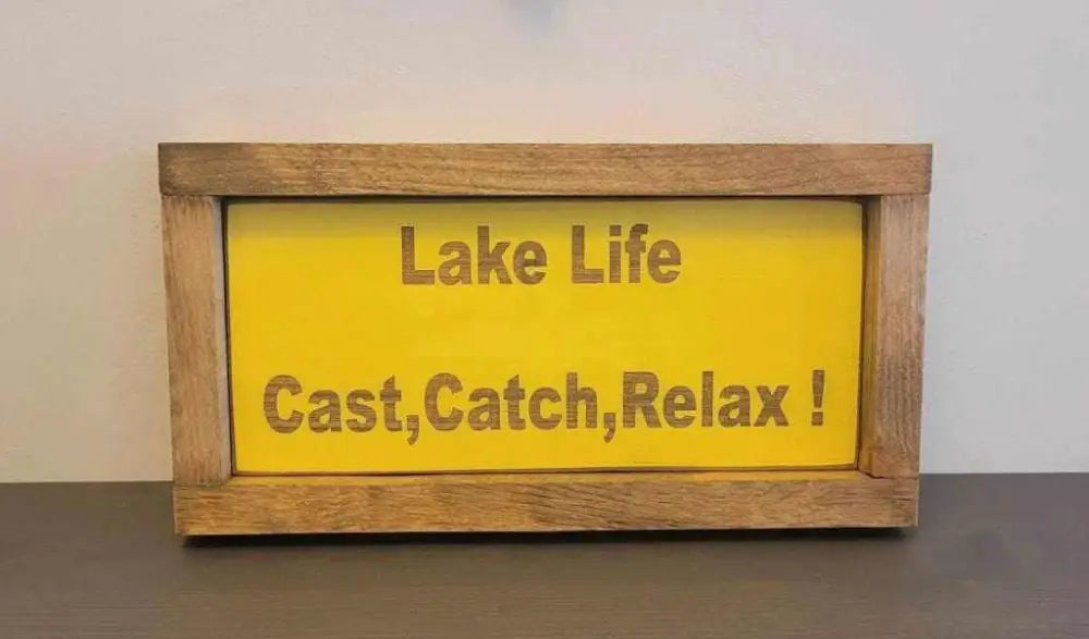 Laser engraved wood sign with "Lake Life, Cast, Catch, Relax" message in rustic frame.