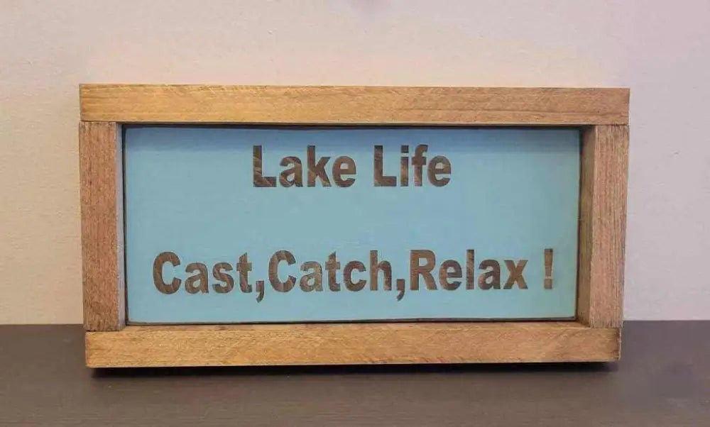 Laser engraved wood sign with "Lake Life, Cast, Catch, Relax!" text, perfect for outdoor enthusiasts.