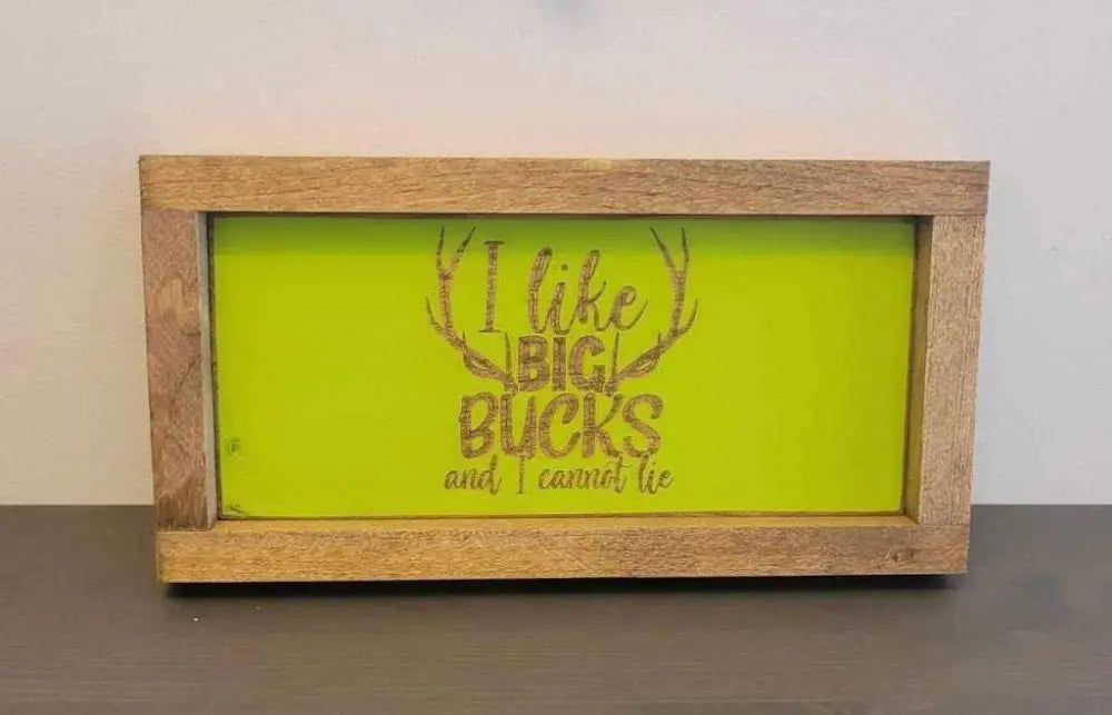 Laser engraved wood sign with "I like big bucks and I cannot lie" design for outdoor enthusiasts.