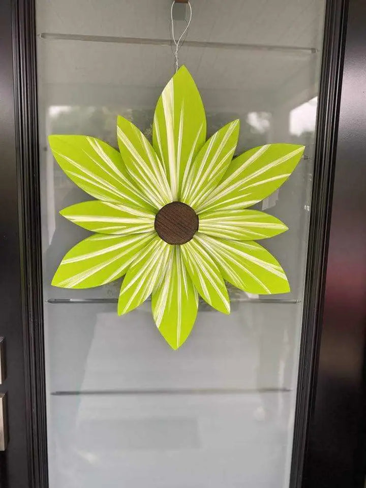 Handcrafted lime wood flower art made from pine, painted in bright green suitable for indoor and outdoor decor.